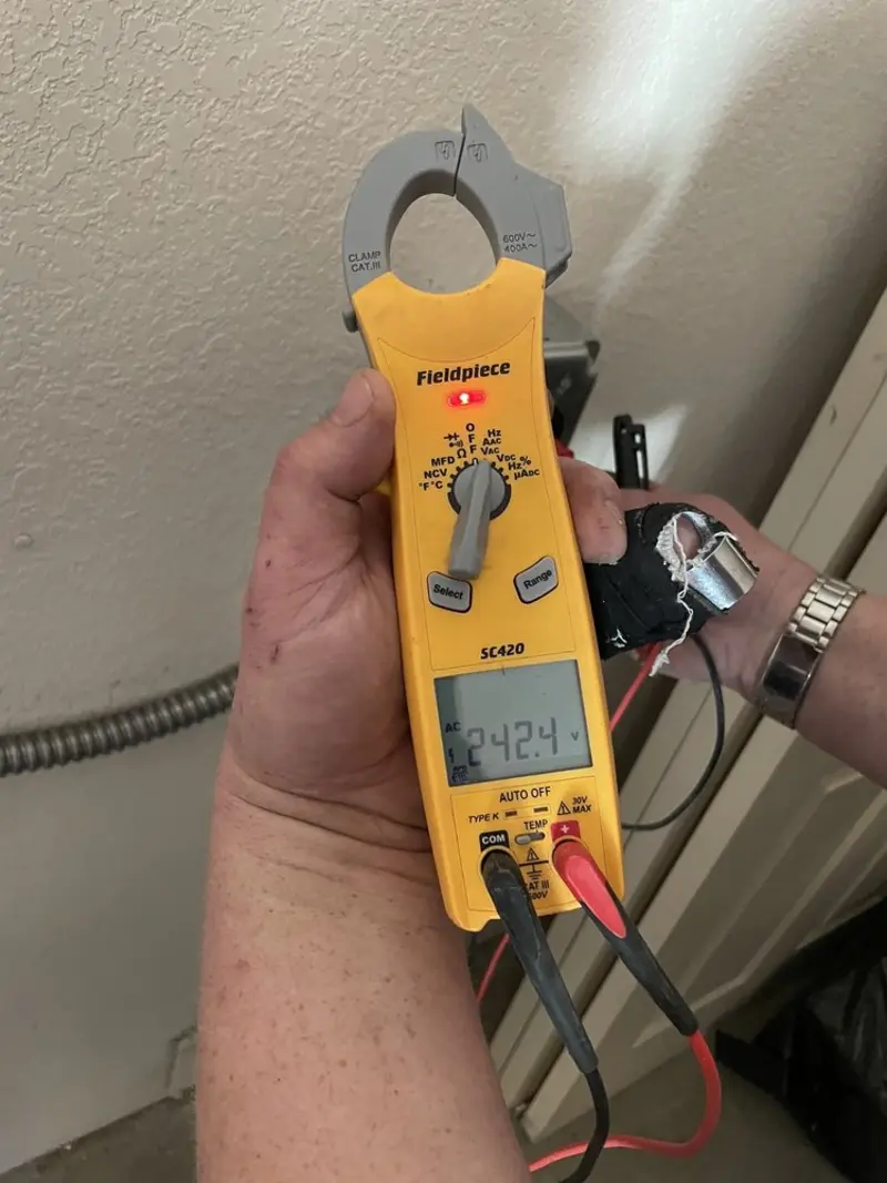 Voltage testing with clamp meter during Recessed Lighting Installation in Spencer